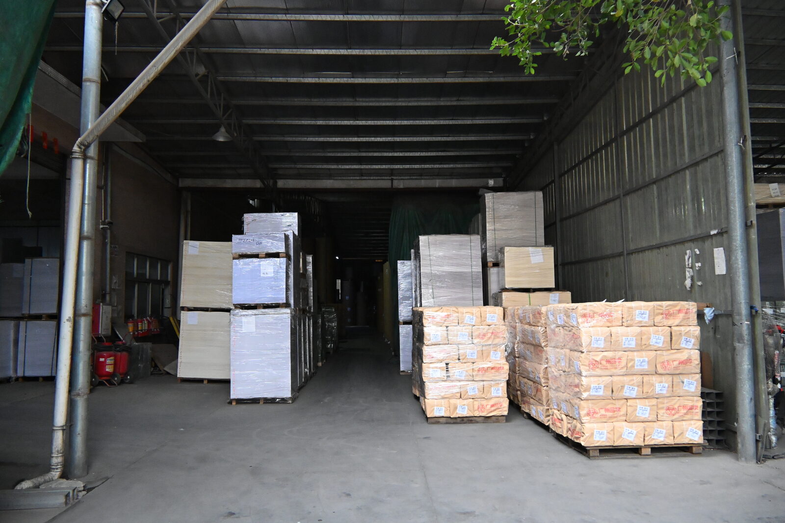 Palletized paper stock and packed cartons in the materials warehouse