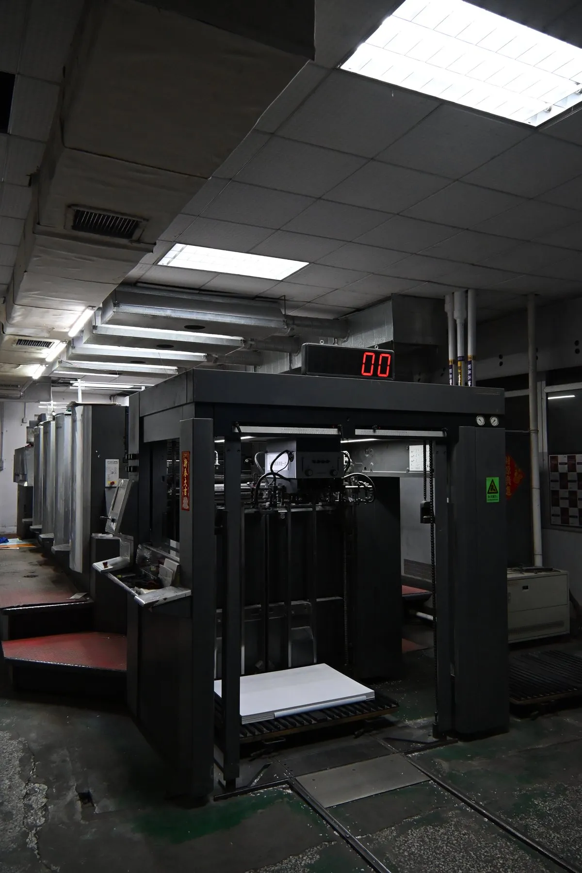 GiltEdgePress operators working beside a Heidelberg printing press